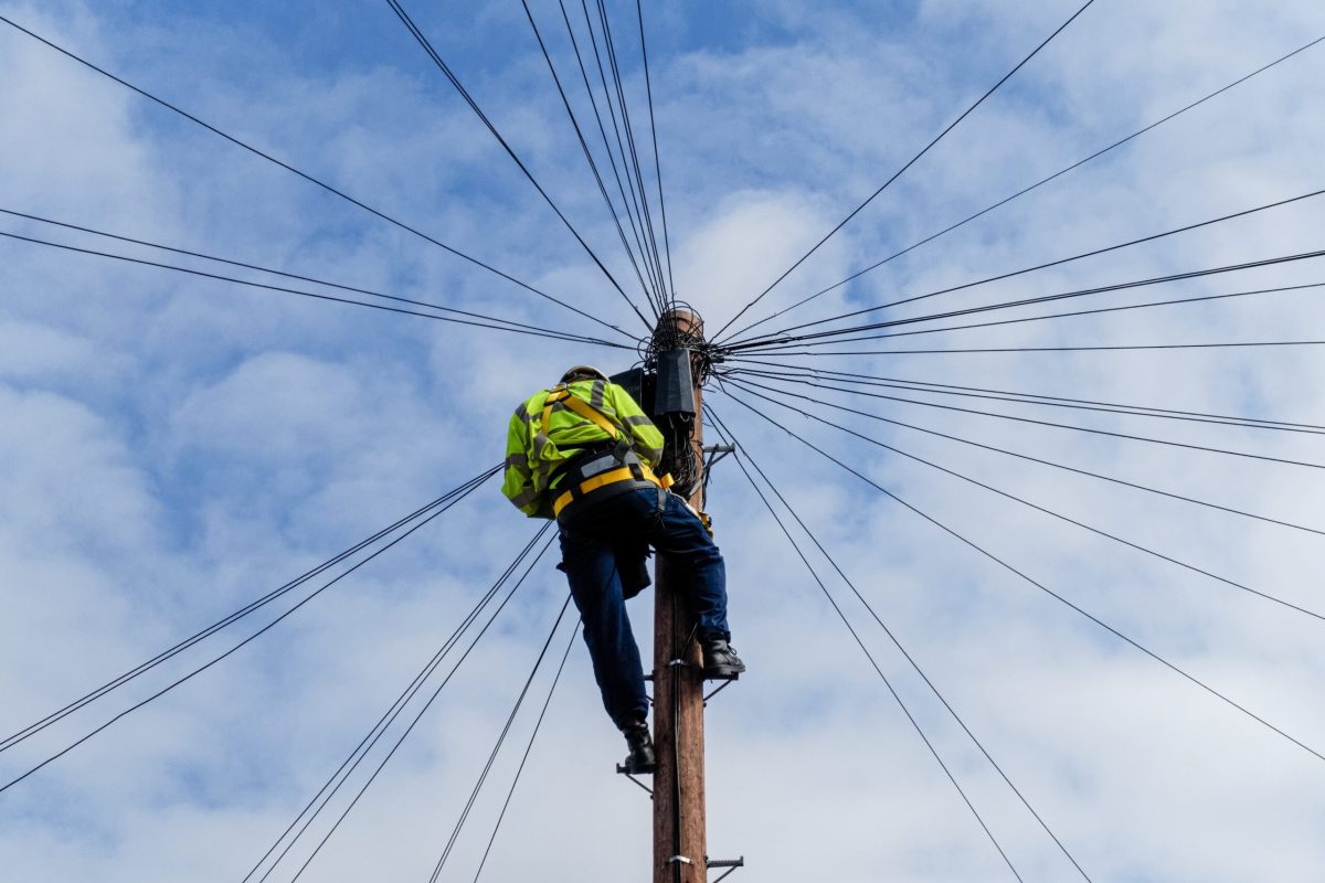 Telecommunications,,Telecom,Engineer,At,Work,On,The,Top,Of,A